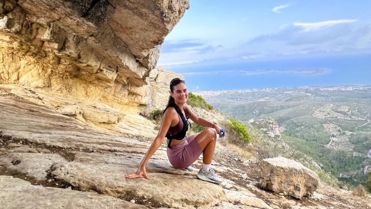 Cèlia Espanya al cim de la Foradada, amb el Delta de l'Ebre de fons, a la Ràpita